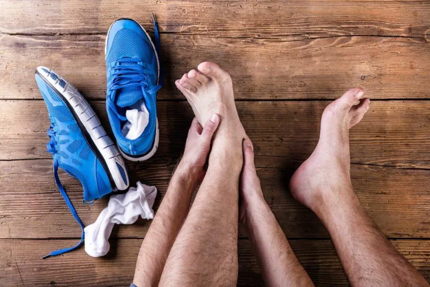Athletic therapist assessing a sprained ankle